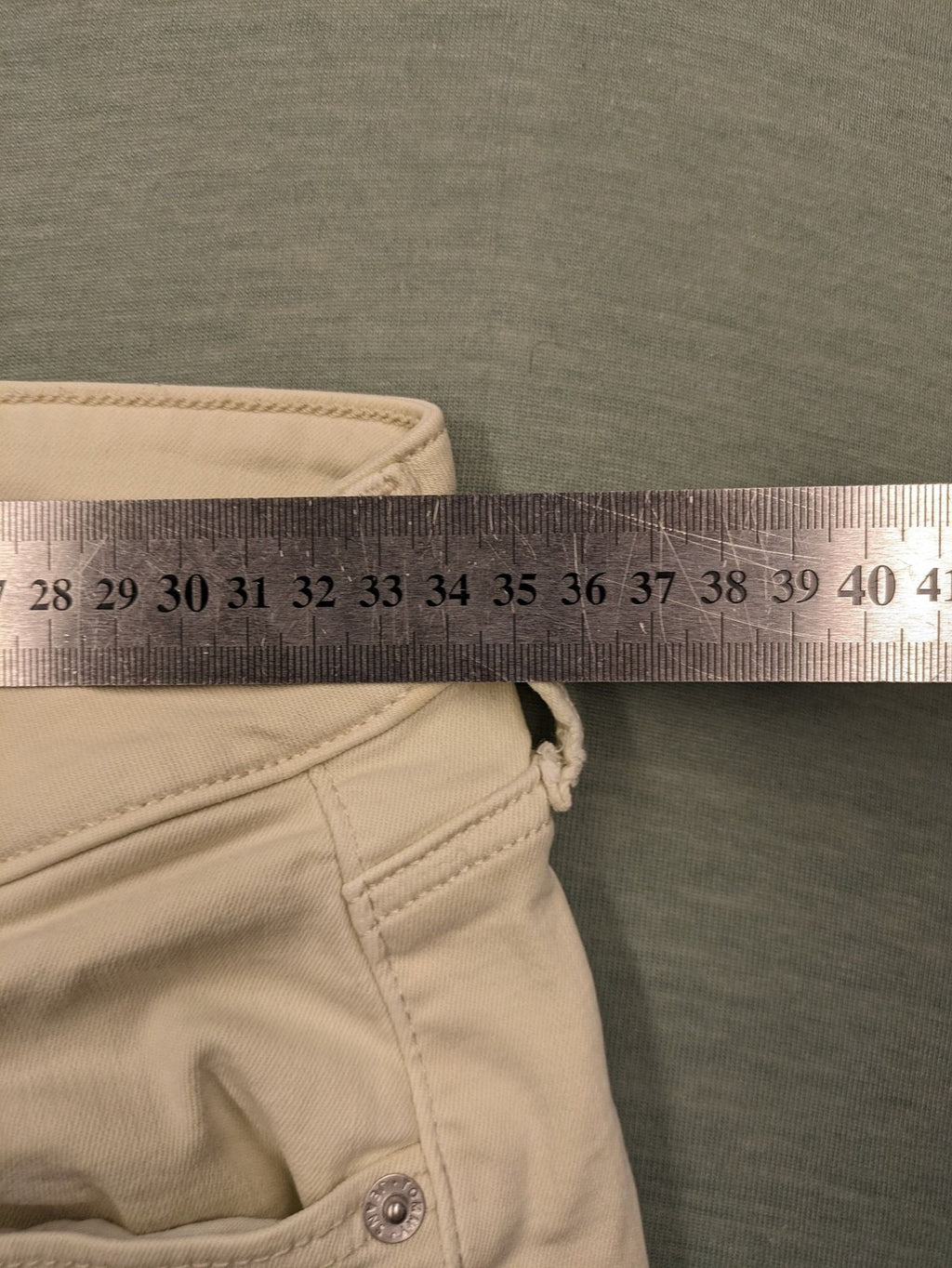 Tommy Jeans beige high rise skinny ankle jeans with logo patch and stretch fabric.