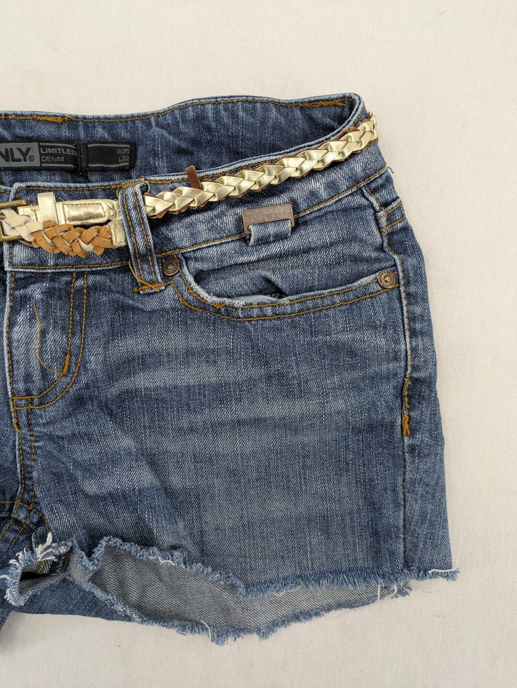 ONLY cream denim shorts with frayed hem and decorative braided gold belt