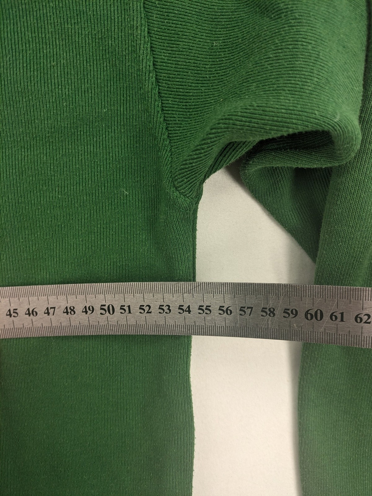 Headlands green turtle neck jumper with gingham collar and "Golden Beach" embroidery.
