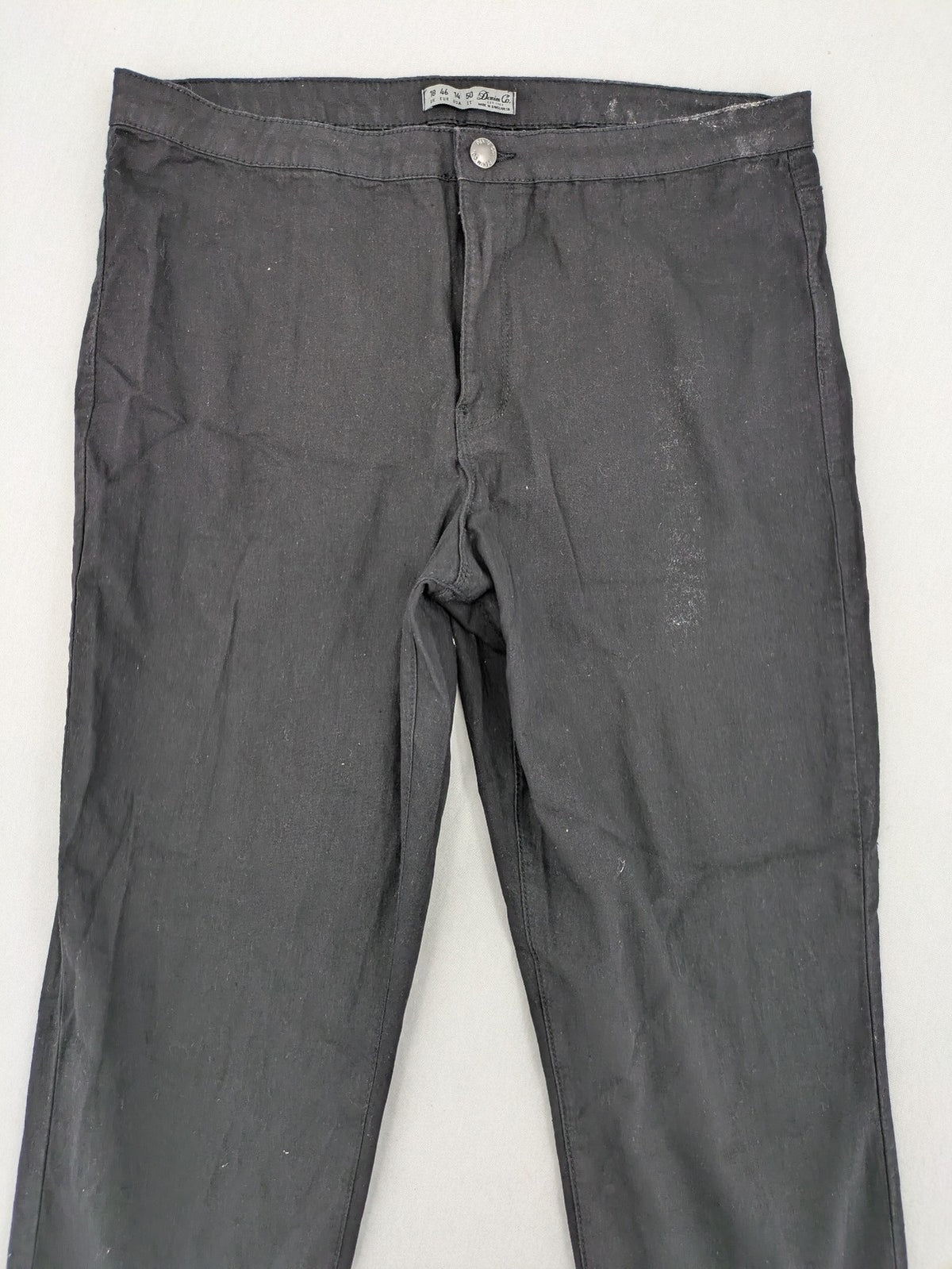 Denim & Co. black straight jeans with front button closure and back pockets.