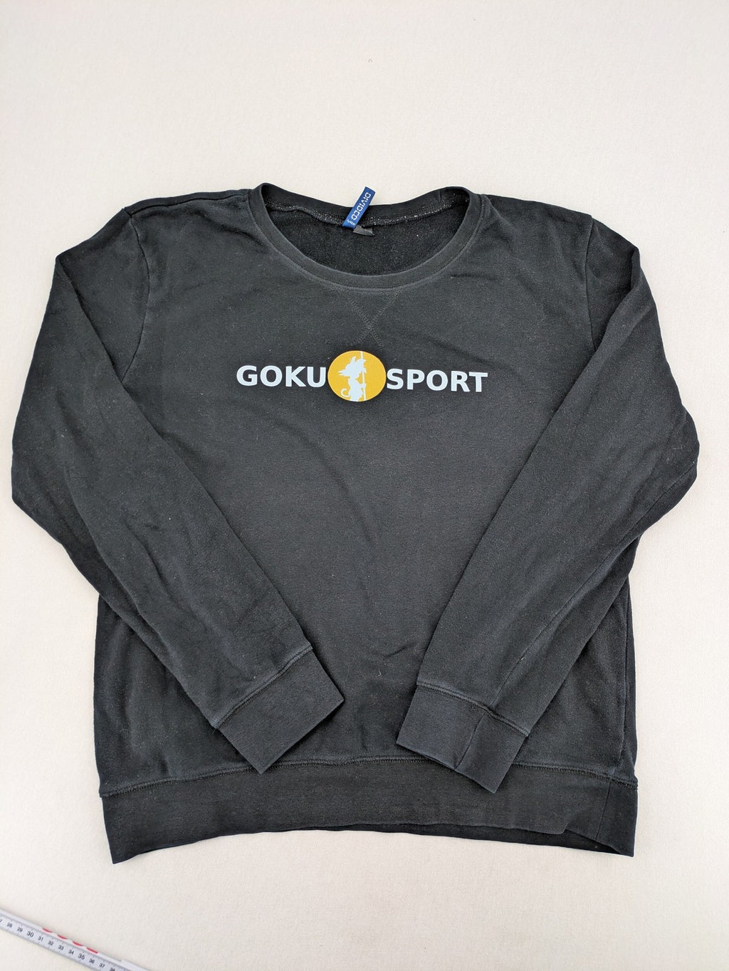 Dragon Ball Z grey turtle neck jumper featuring "GOKU SPORT" graphic print, 100% cotton.