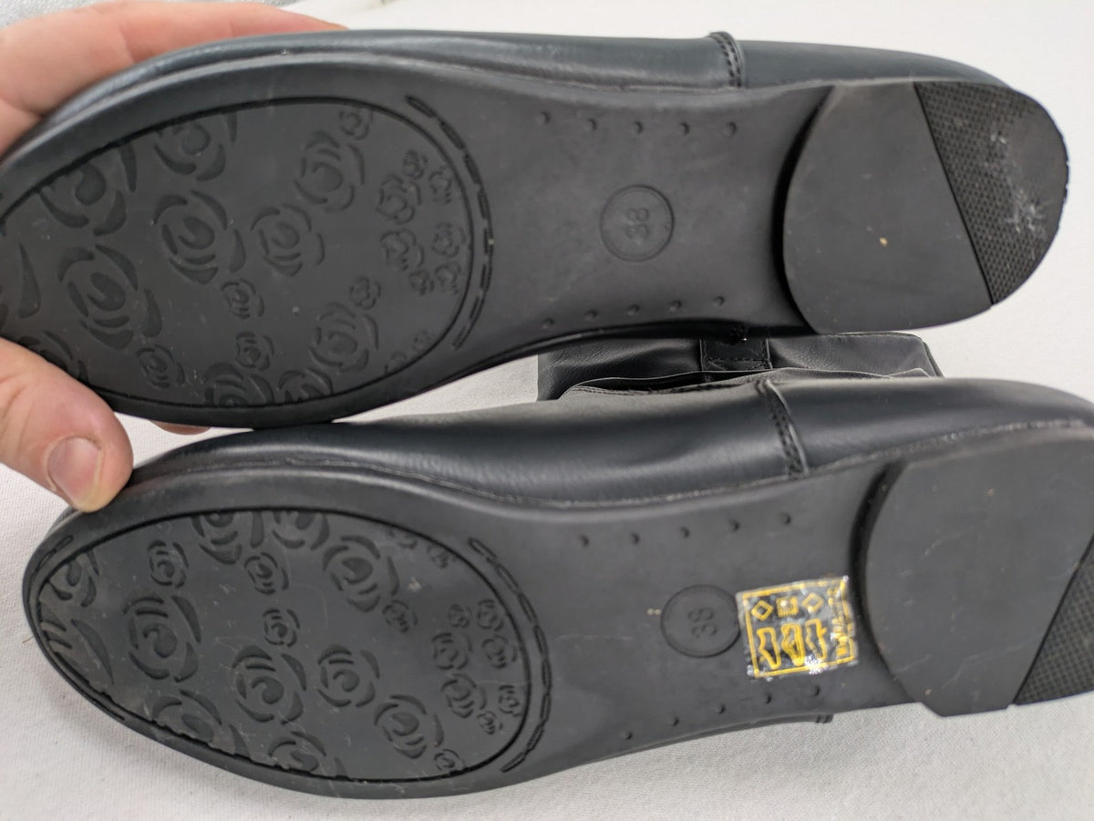 DAF black booties with decorative strap and studded details, made of faux leather.