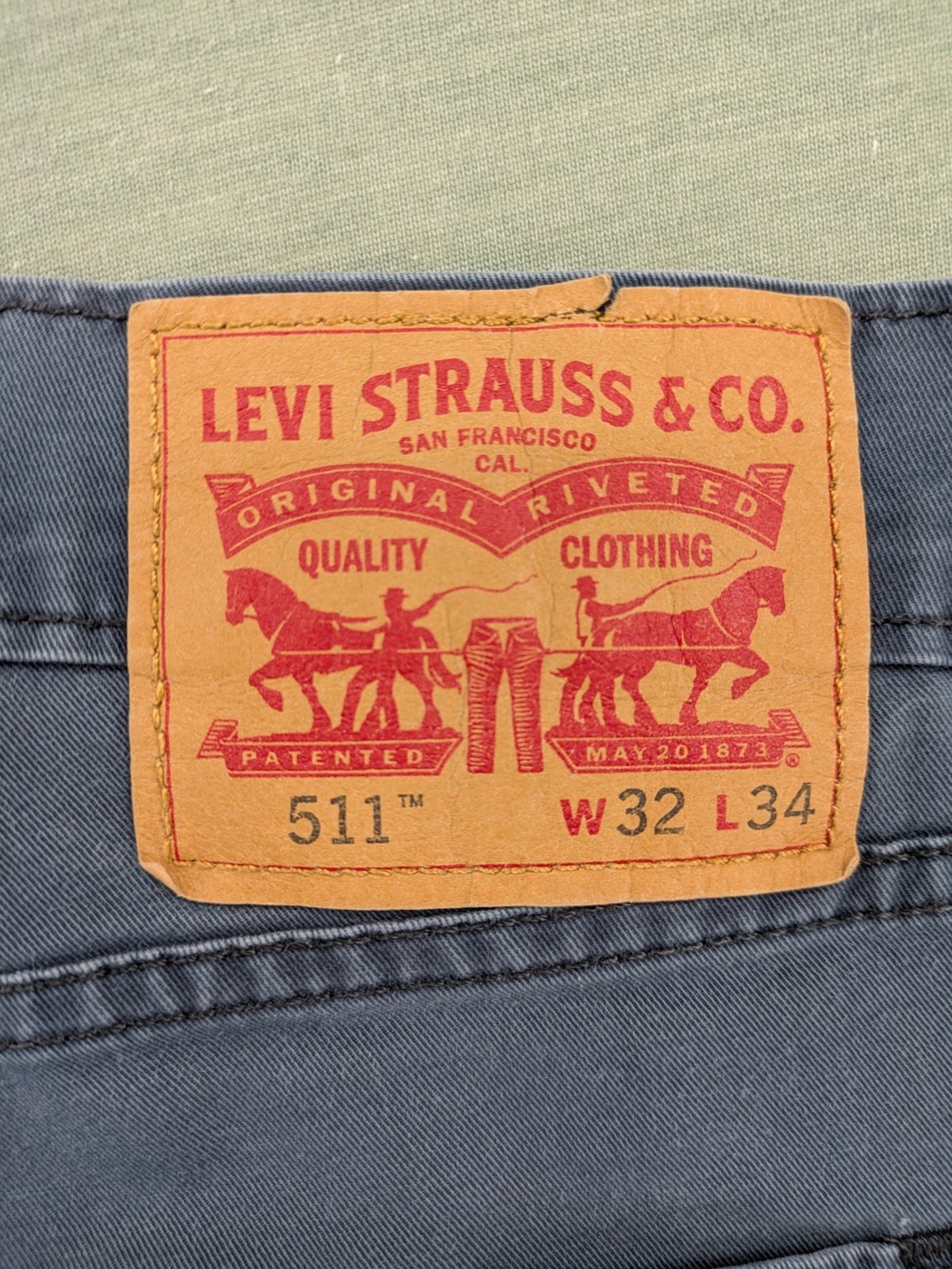 Levi's blue slim fit jeans with faded wash and classic 5-pocket design.