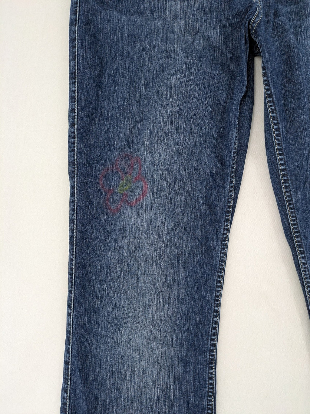 Mustang blue bootcut jeans with custom painted floral designs on both legs.