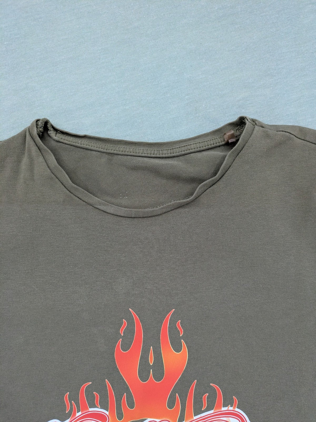 Aerosmith khaki band t-shirt featuring large flaming skull graphic and logo, slim fit.