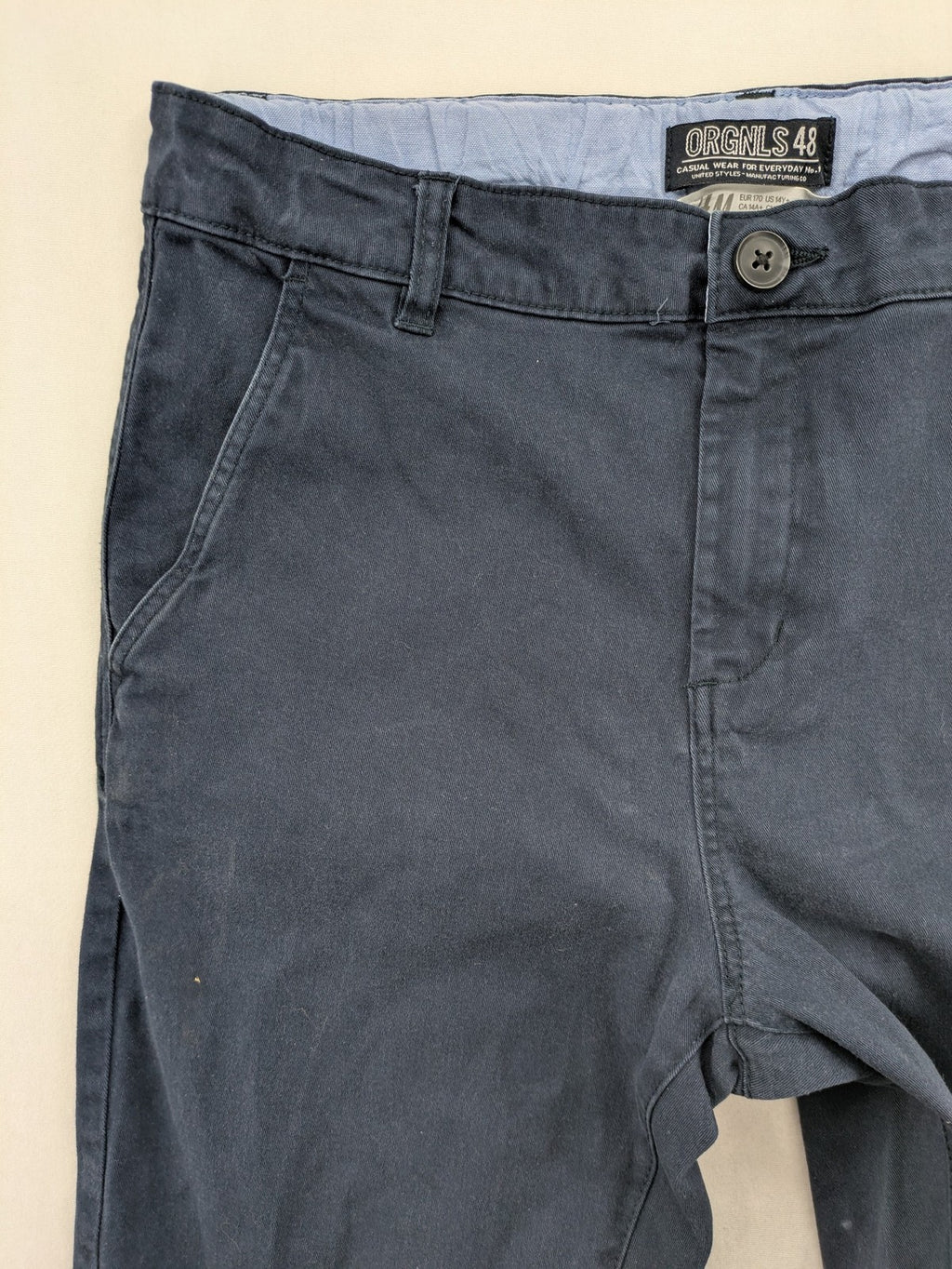 H&M navy chino pants with stretch, classic design, soft cotton blend material.