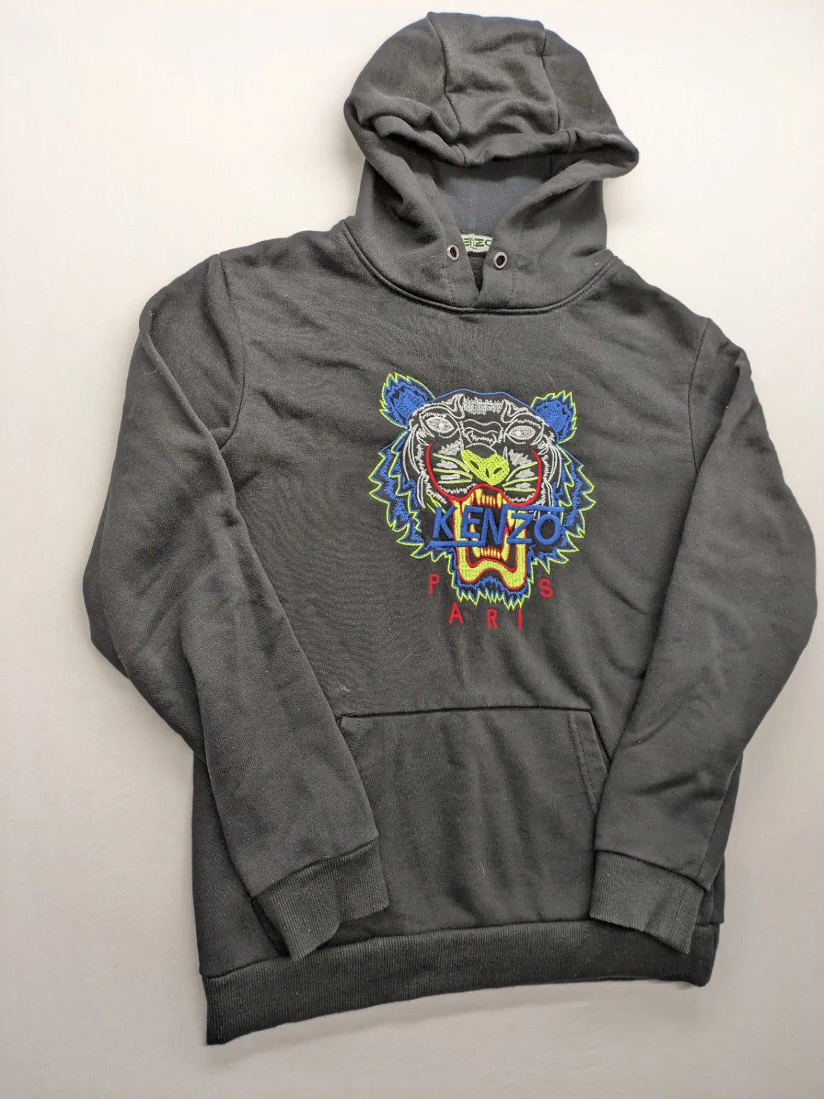Kenzo multi hoodie with embroidered tiger graphic, drawstring hood, and kangaroo pocket.
