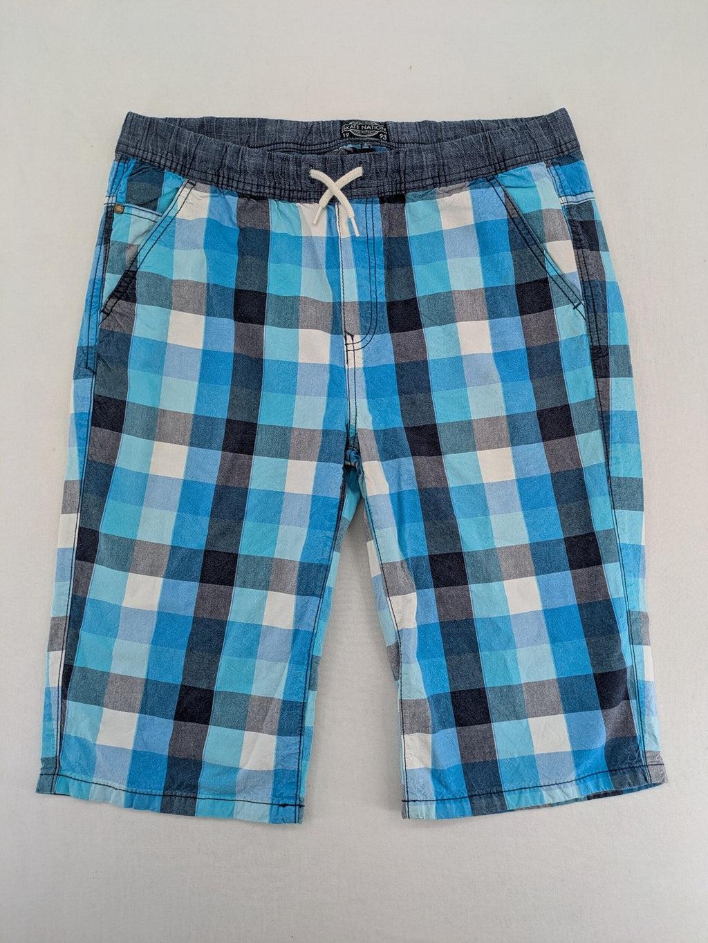 C&A blue checkered shorts with elastic waistband and side pockets, Skate Nation style.