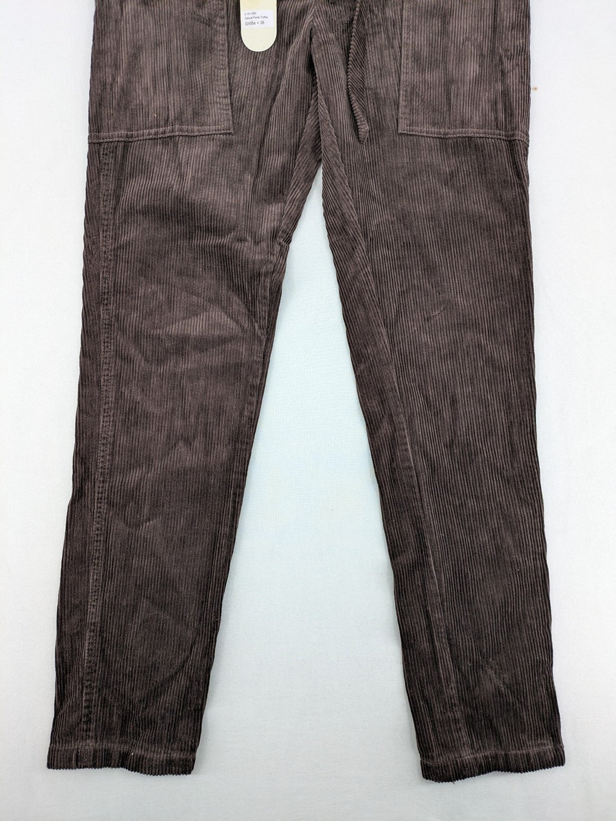 Alma & Lovis cream cord pants high-waist with matching belt and front pockets.