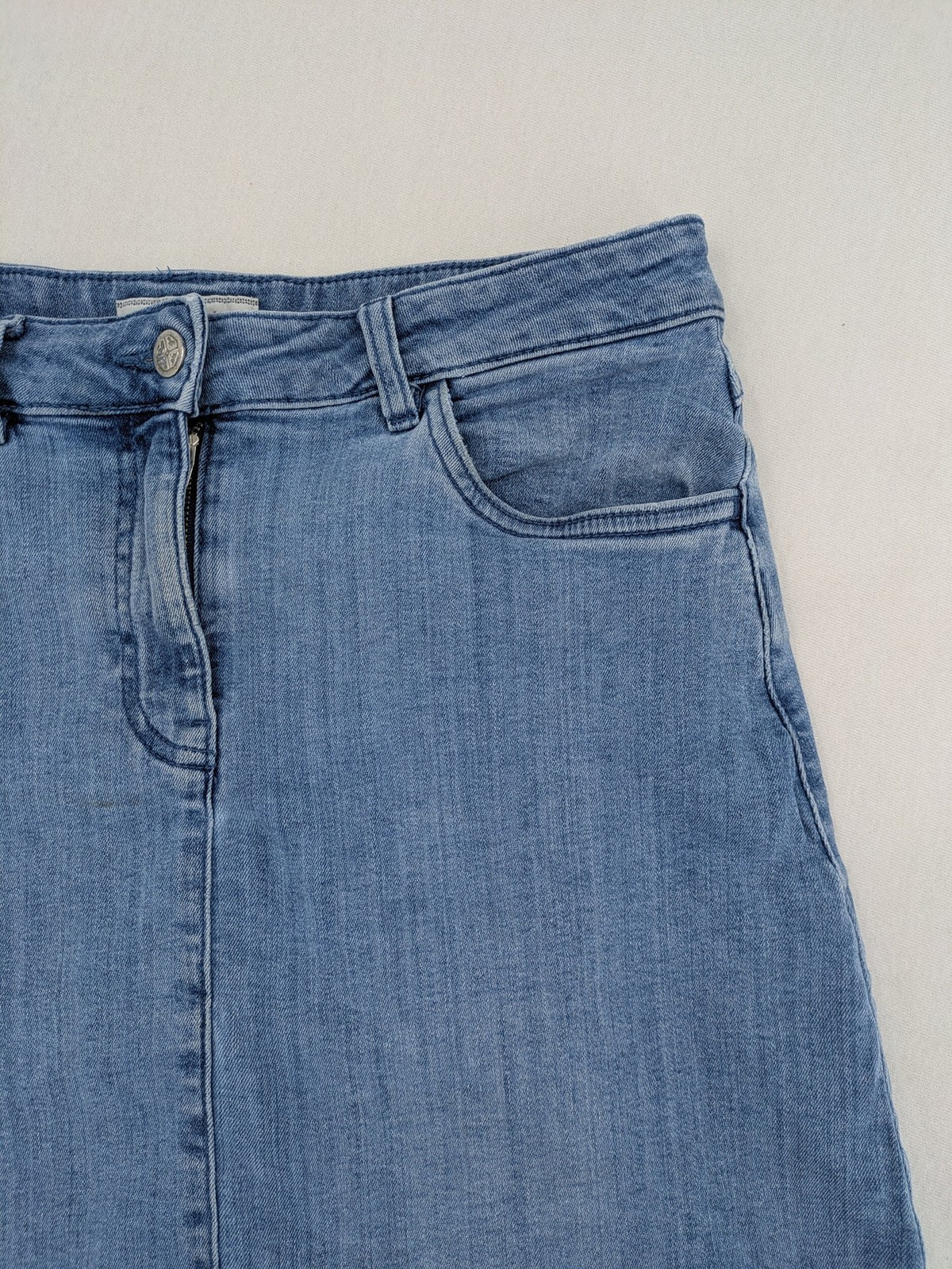 Tchibo blue A-line denim skirt classic five-pocket design with zipper and button closure.