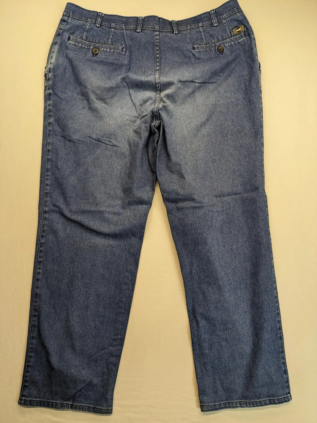 REI blue straight jeans with front pleats, zip fly, and buttoned back pockets.