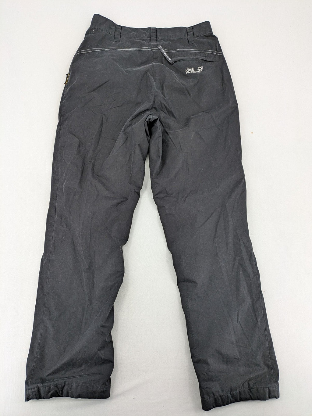 Jack Wolfskin grey outdoor pants with embroidered logo and side zip pocket.