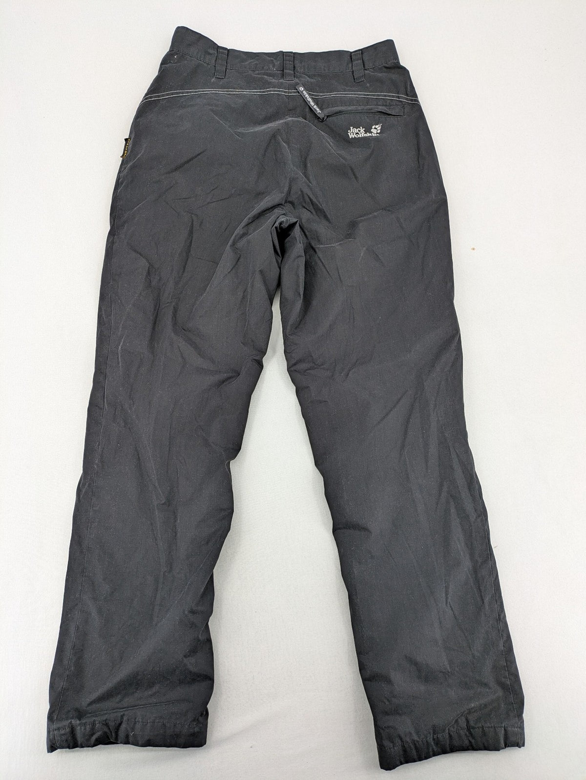 Jack Wolfskin grey outdoor pants with embroidered logo and side zip pocket.