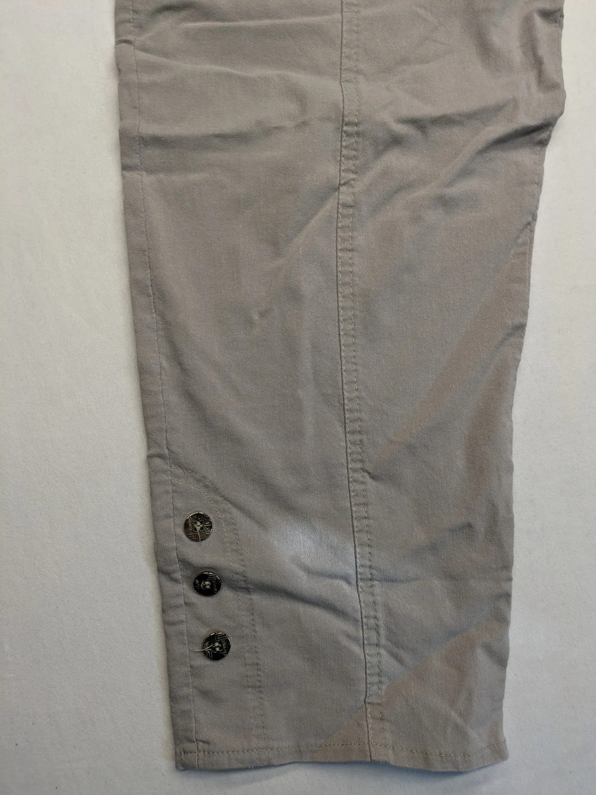 Cherry Berry khaki capri pants with elastic waistband and decorative buttons, featuring logo and zip pockets.