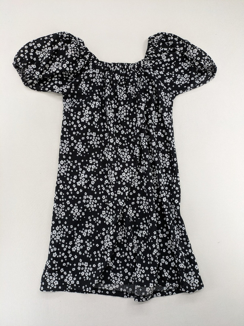 Clockhouse black and white floral mini dress with smocked bodice and puff sleeves.