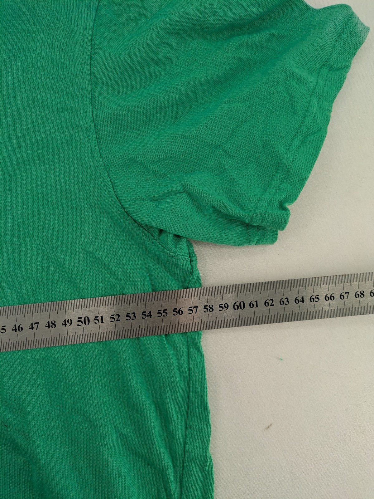 Myla green graphic t-shirt with large peace earth print and front pocket design.