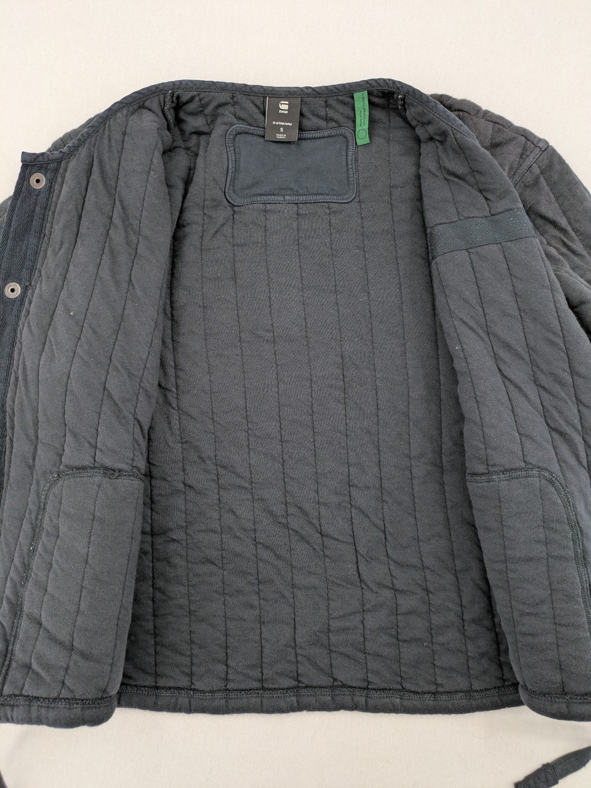 G-Star Raw grey quilted jacket with button closure and adjustable drawstring hem.