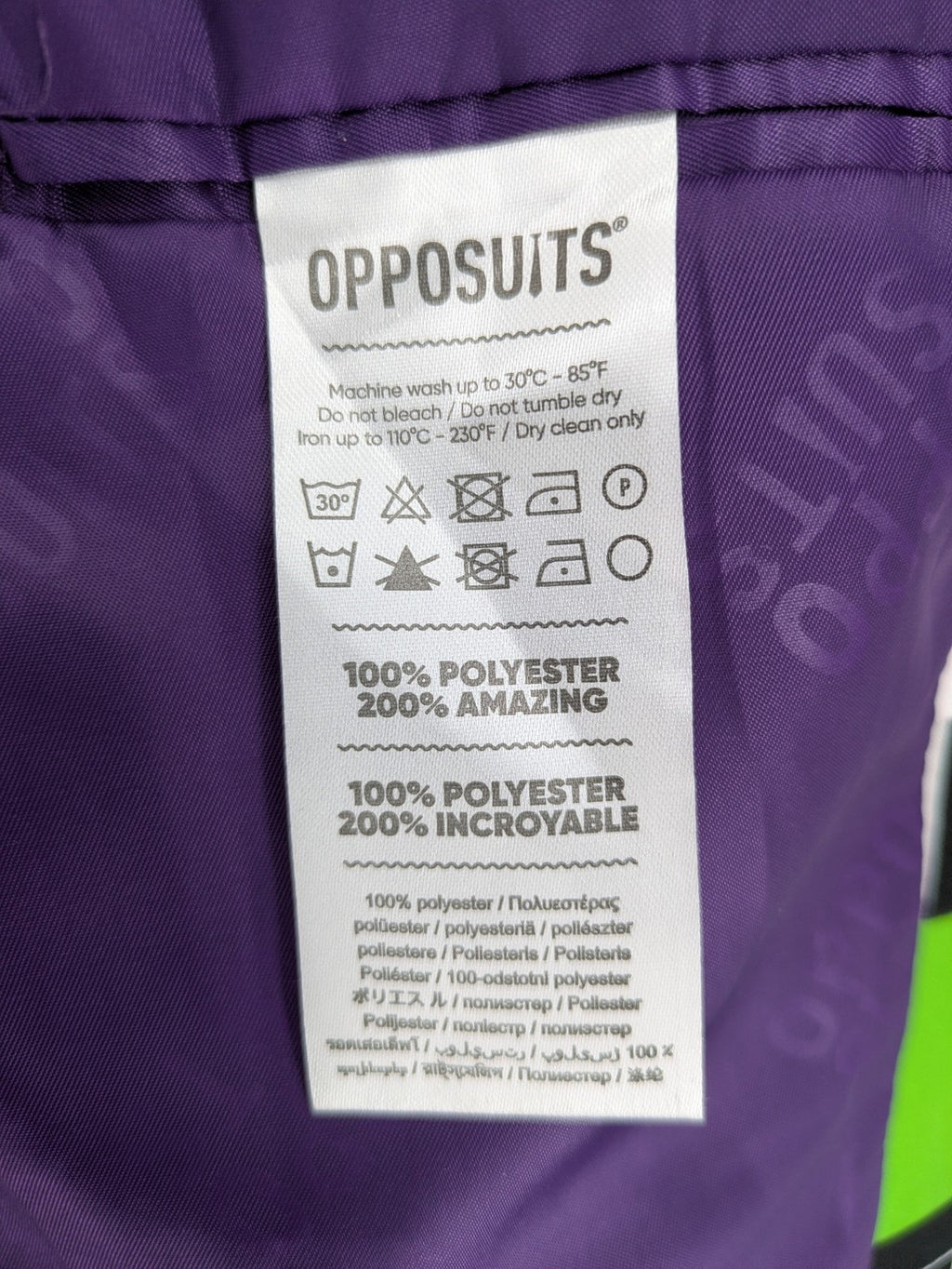 Opposuits blue and green blazer with vibrant geometric pattern and purple satin lining.