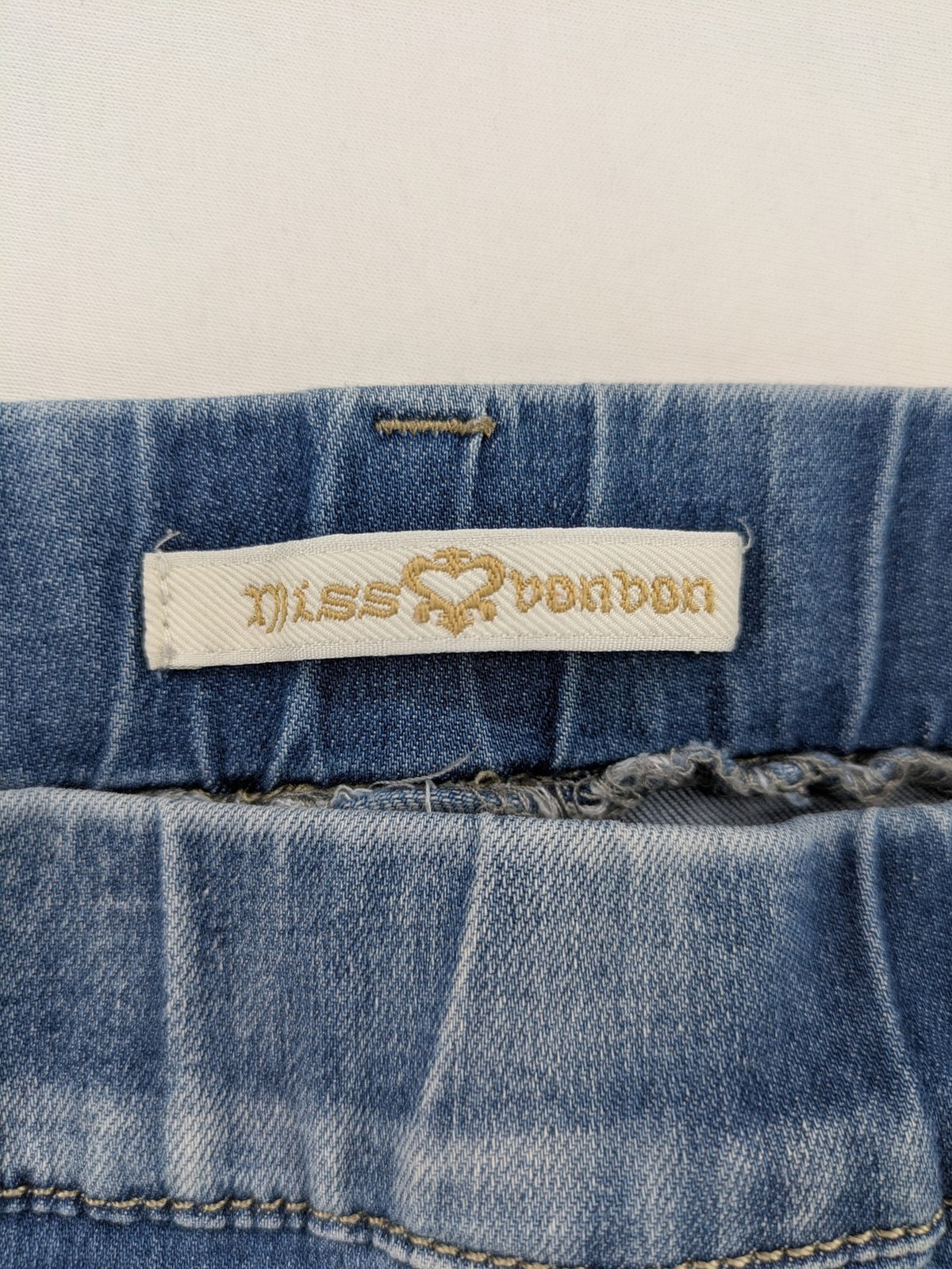 Miss Bonbon blue skinny jeans jeggings with elastic pull-on waistband and light wash.