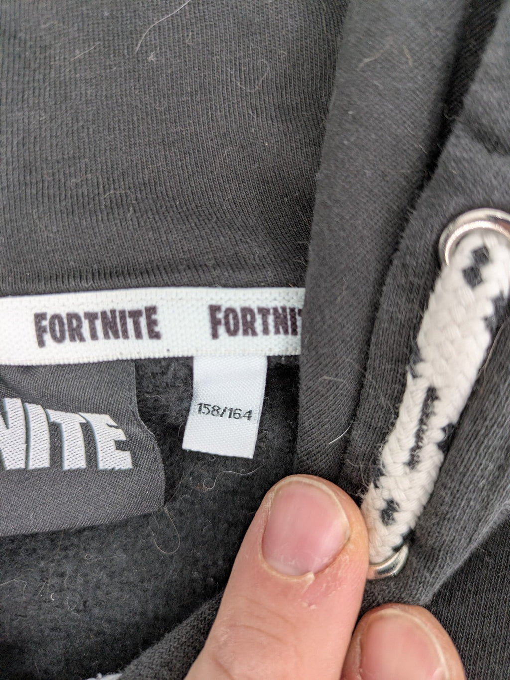 Fortnite black zip-through hoodie with logo on sleeves and Black Knight patch on chest.