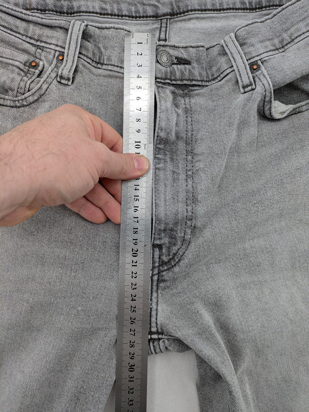 Levi's grey slim fit jeans with distressed knee details and classic logo patch.