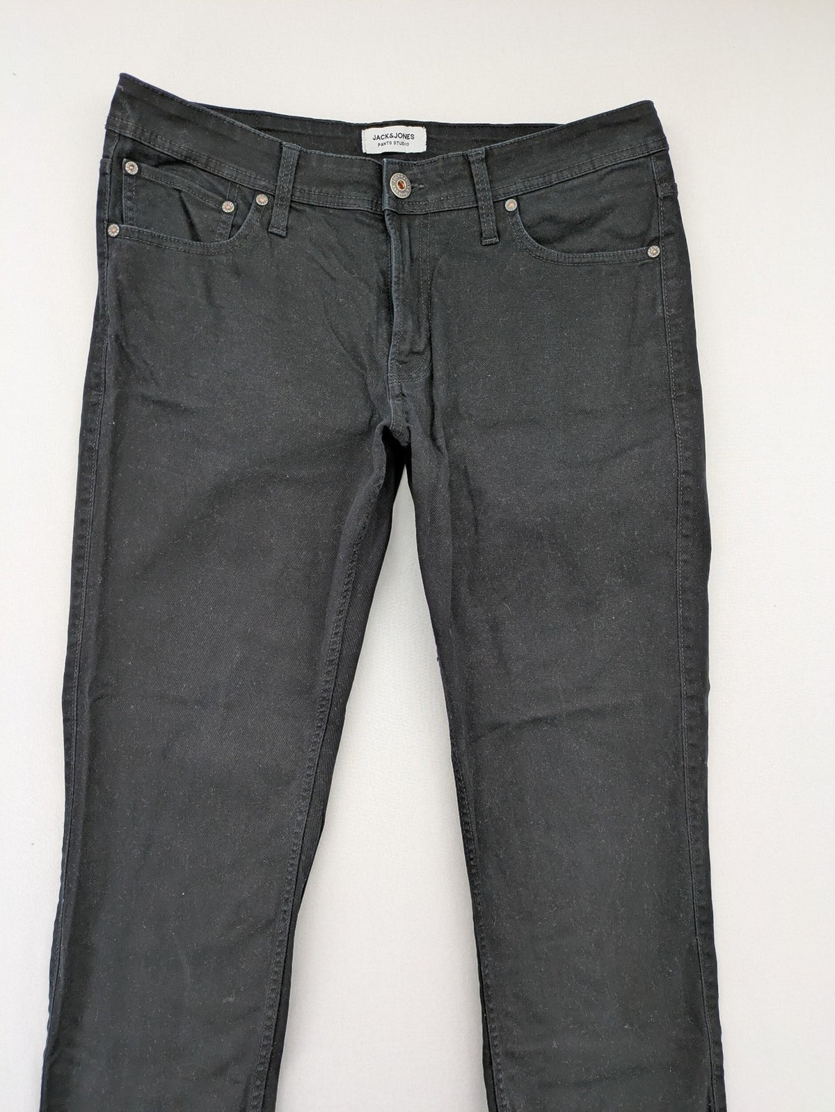 Jack & Jones black slim fit jeans with logo patch and cotton-stretch blend.
