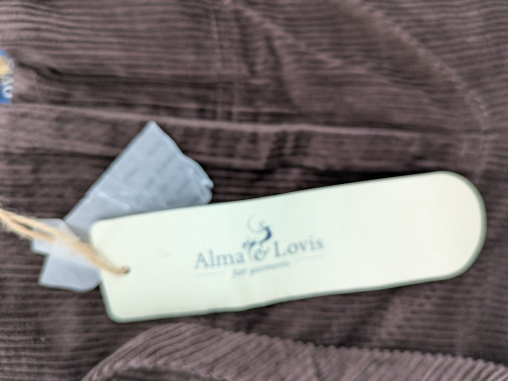 Alma & Lovis brown cord pants with elastic waistband, drawstring, and front patch pockets.