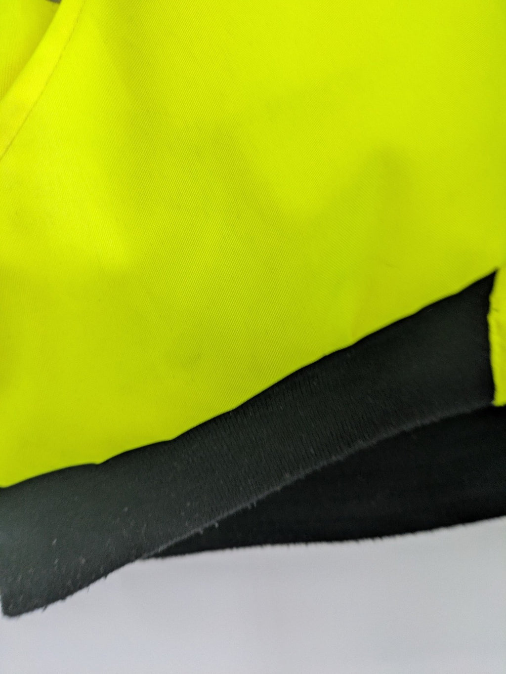 Hüren OHG grey and neon yellow safety jacket with reflective stripes and zippered arm pocket.