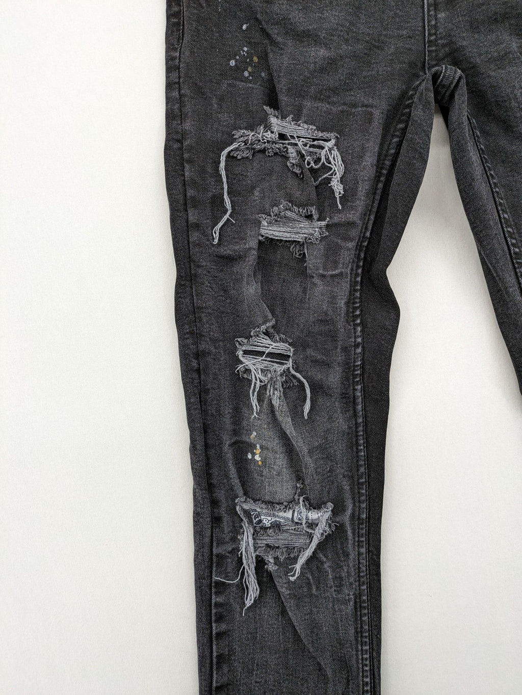 Black Squad skinny fit jeans black distressed ripped design with subtle paint splatter.