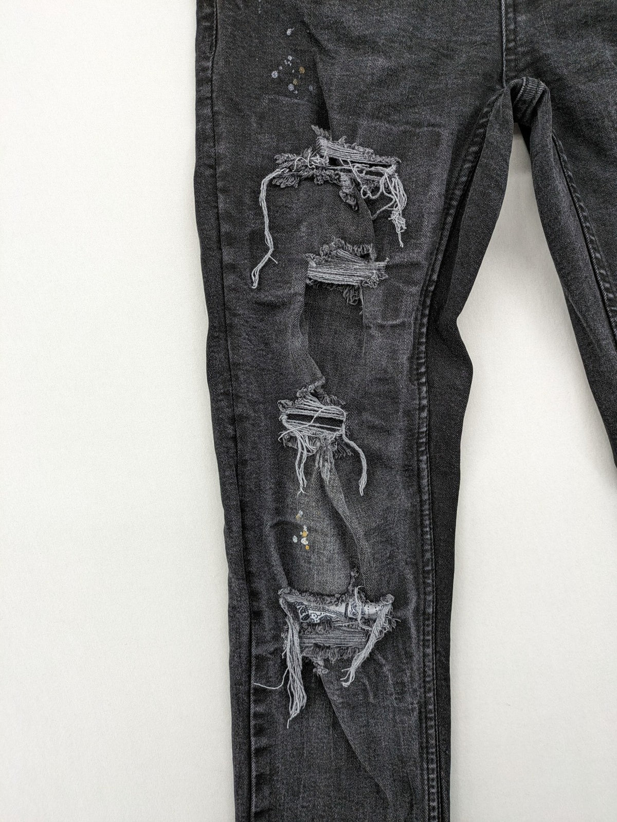 Black Squad skinny fit jeans black distressed ripped design with subtle paint splatter.