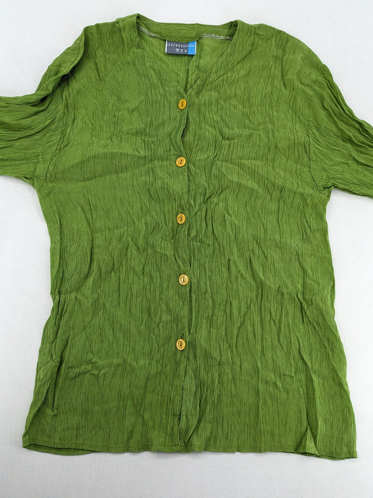 Expressions green blouse with V-neck, button front, and crinkle texture.