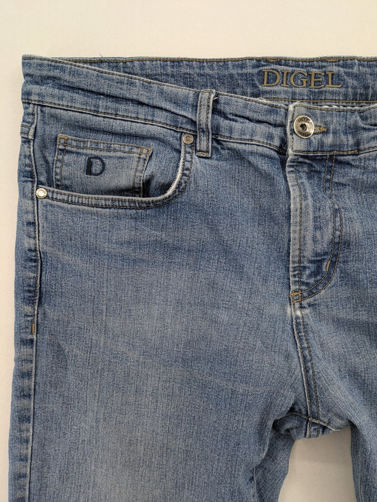 Digel blue straight jeans with classic medium wash and durable cotton denim material.