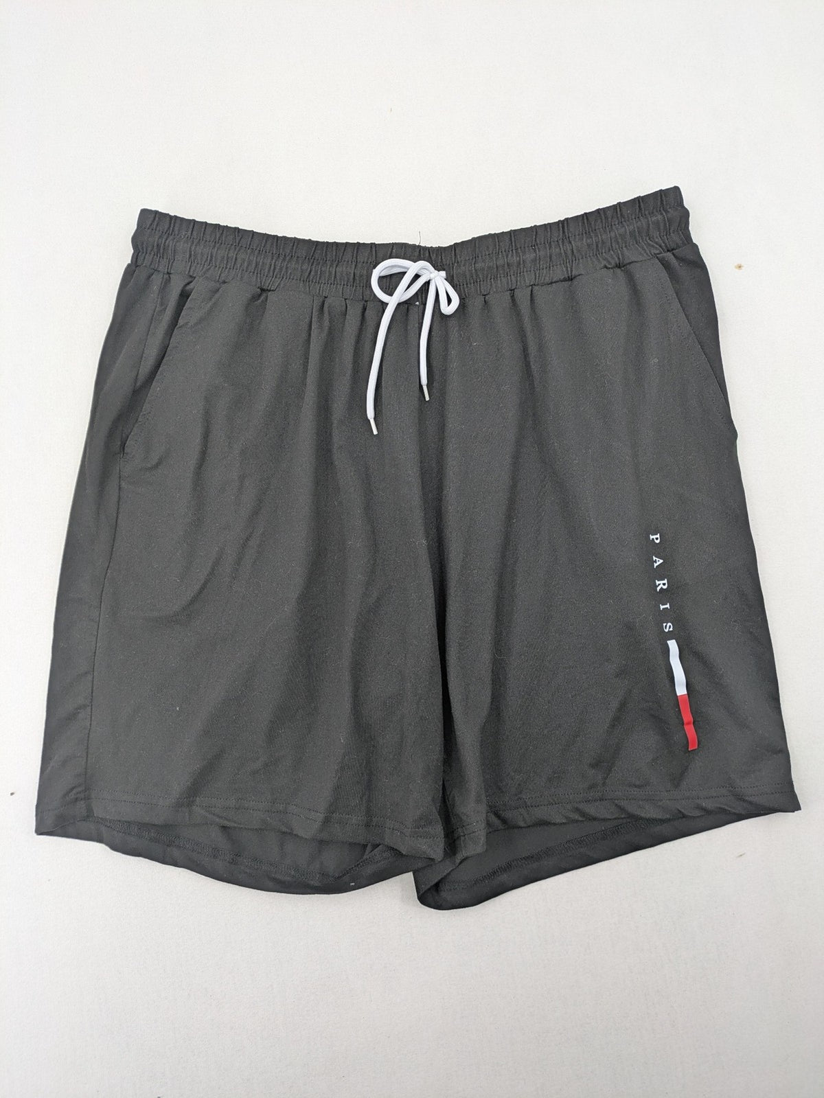 Manfinity loungewear set black T-shirt and shorts with Paris graphic print.