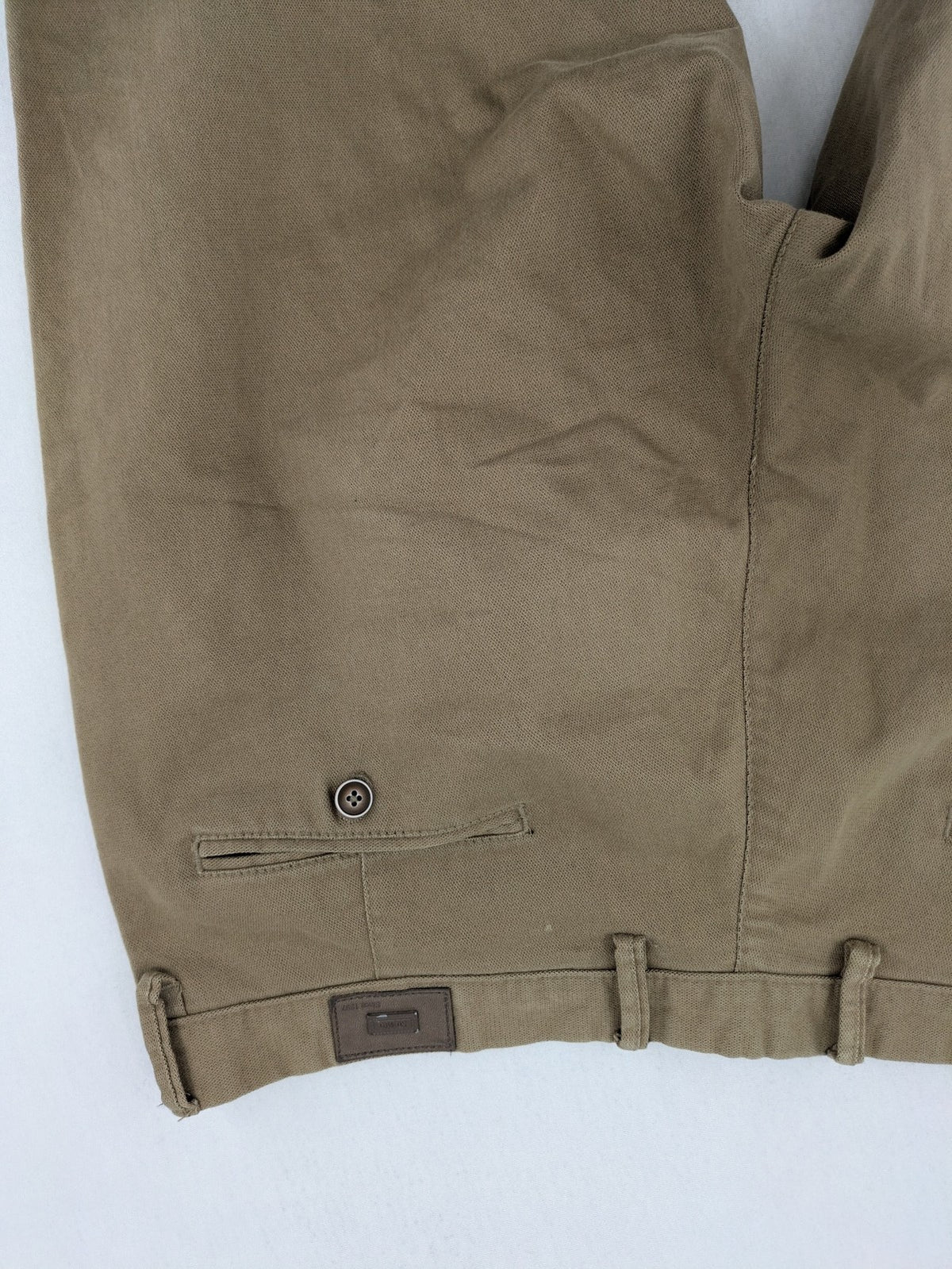 Süvari khaki chino pants flat-front design with patterned waistband detail, cotton blend material.