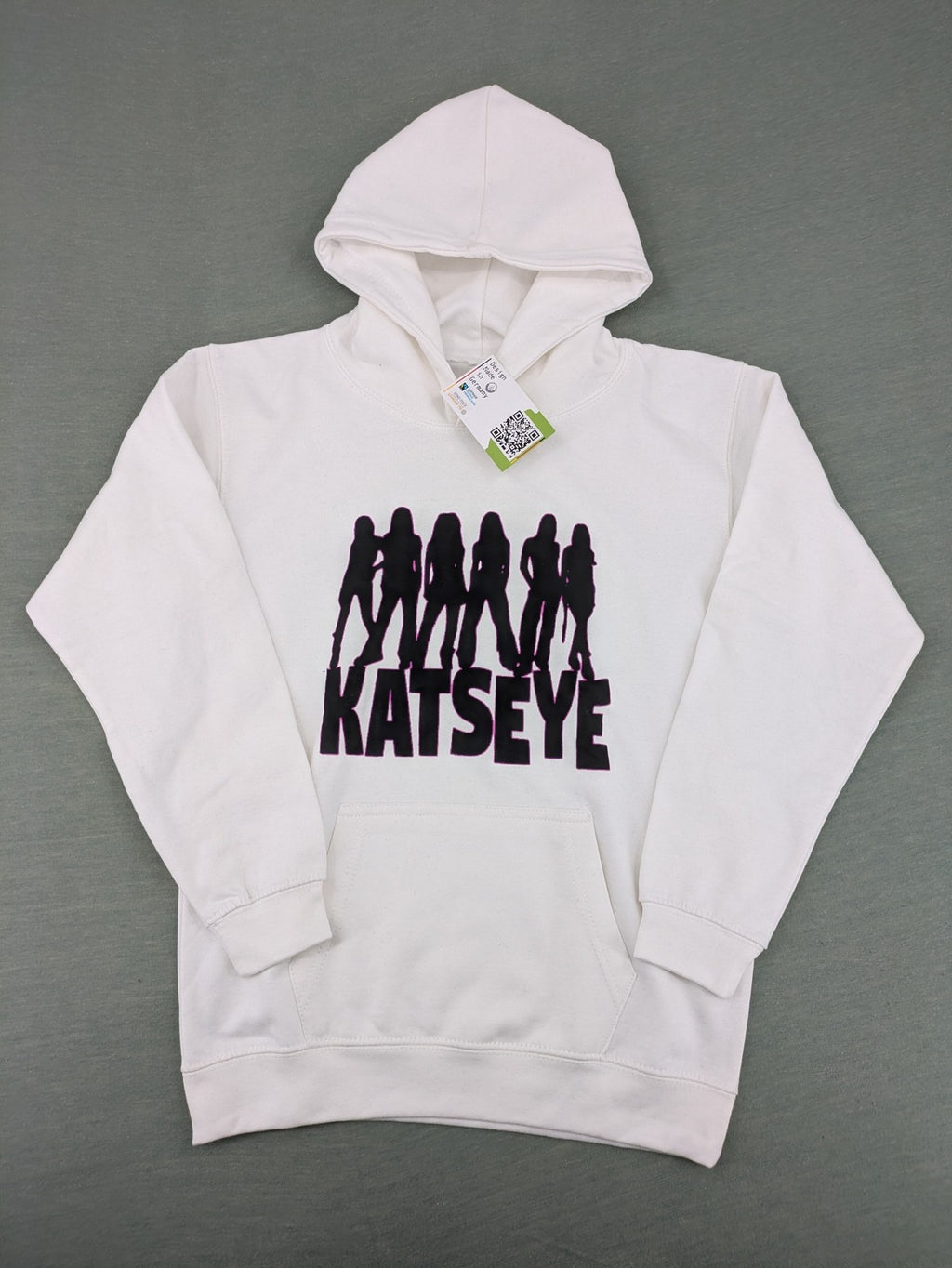KATSEYE white zip-through hoodie with black silhouette graphic and logo, classic pullover style.