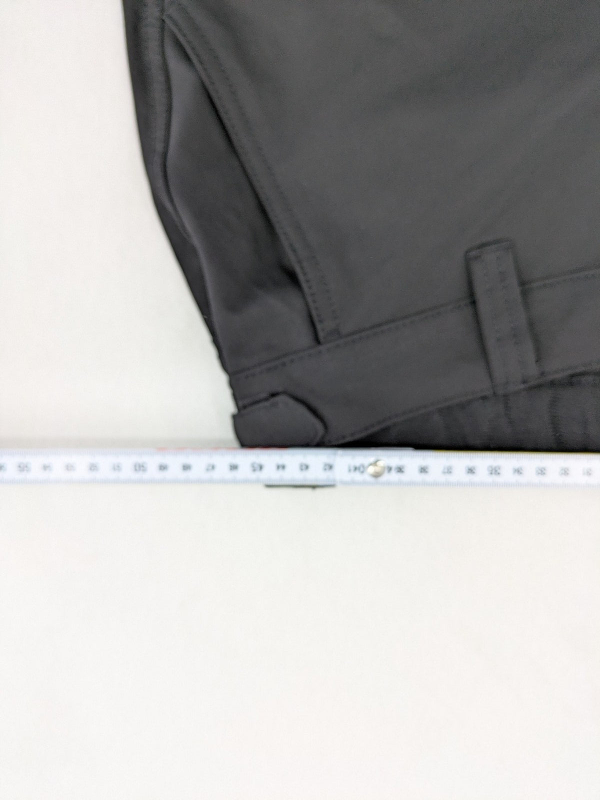 Outdoor grey trekking pants with zippered cargo pockets and durable stretch fabric.