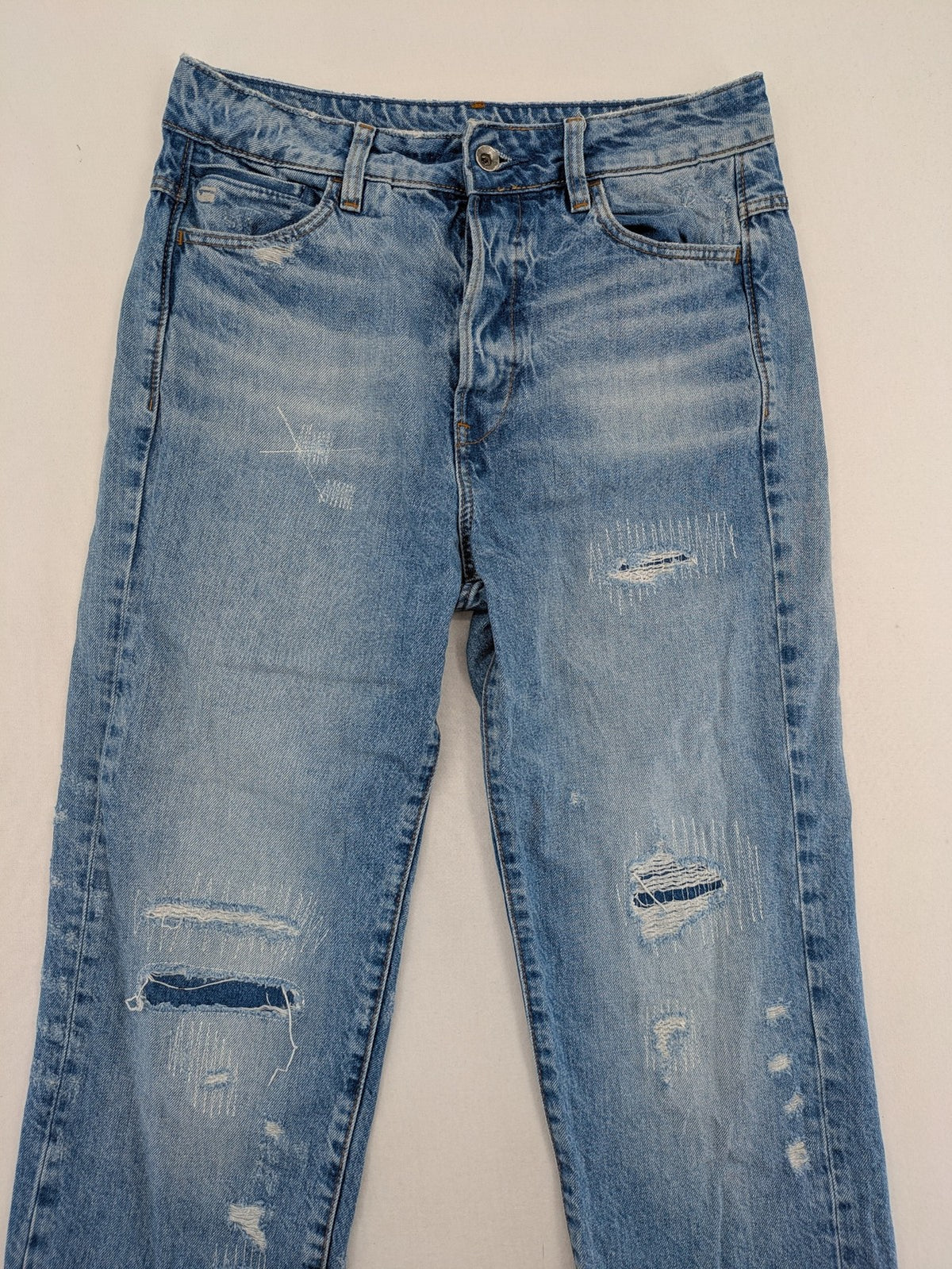 G-Star Raw blue distressed high boyfriend jeans with ripped details and classic button closure.