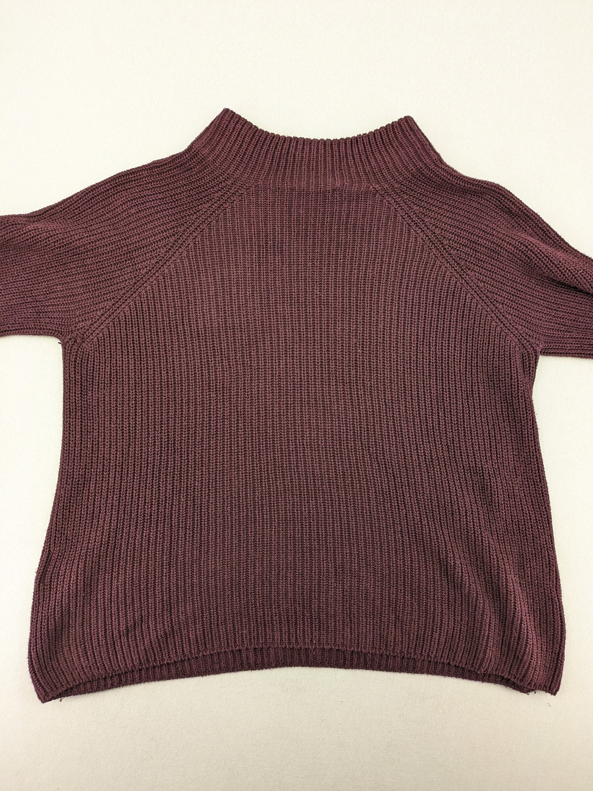 Monari burgundy knit jumper with standing collar, ribbed texture, and raglan sleeves.