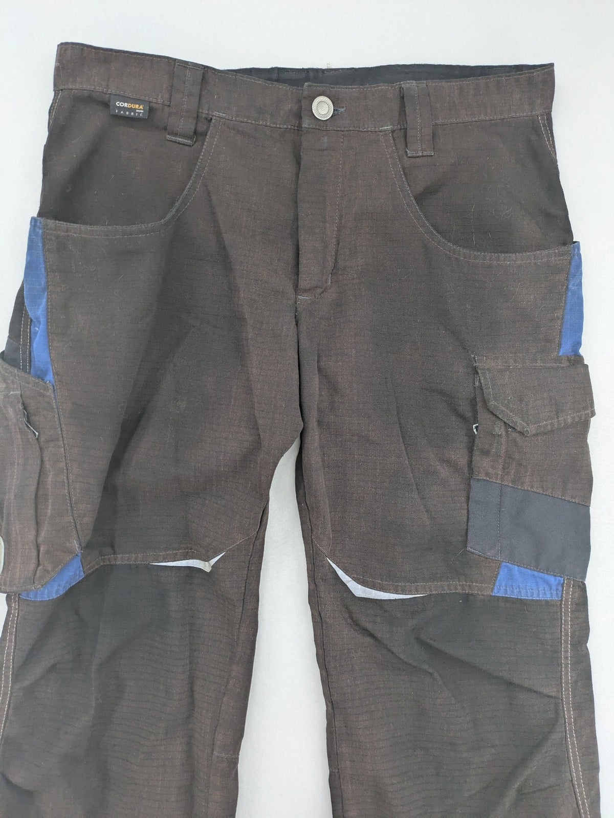 Kübler work pants blue grey Cordura fabric with multiple cargo pockets and reflective details.