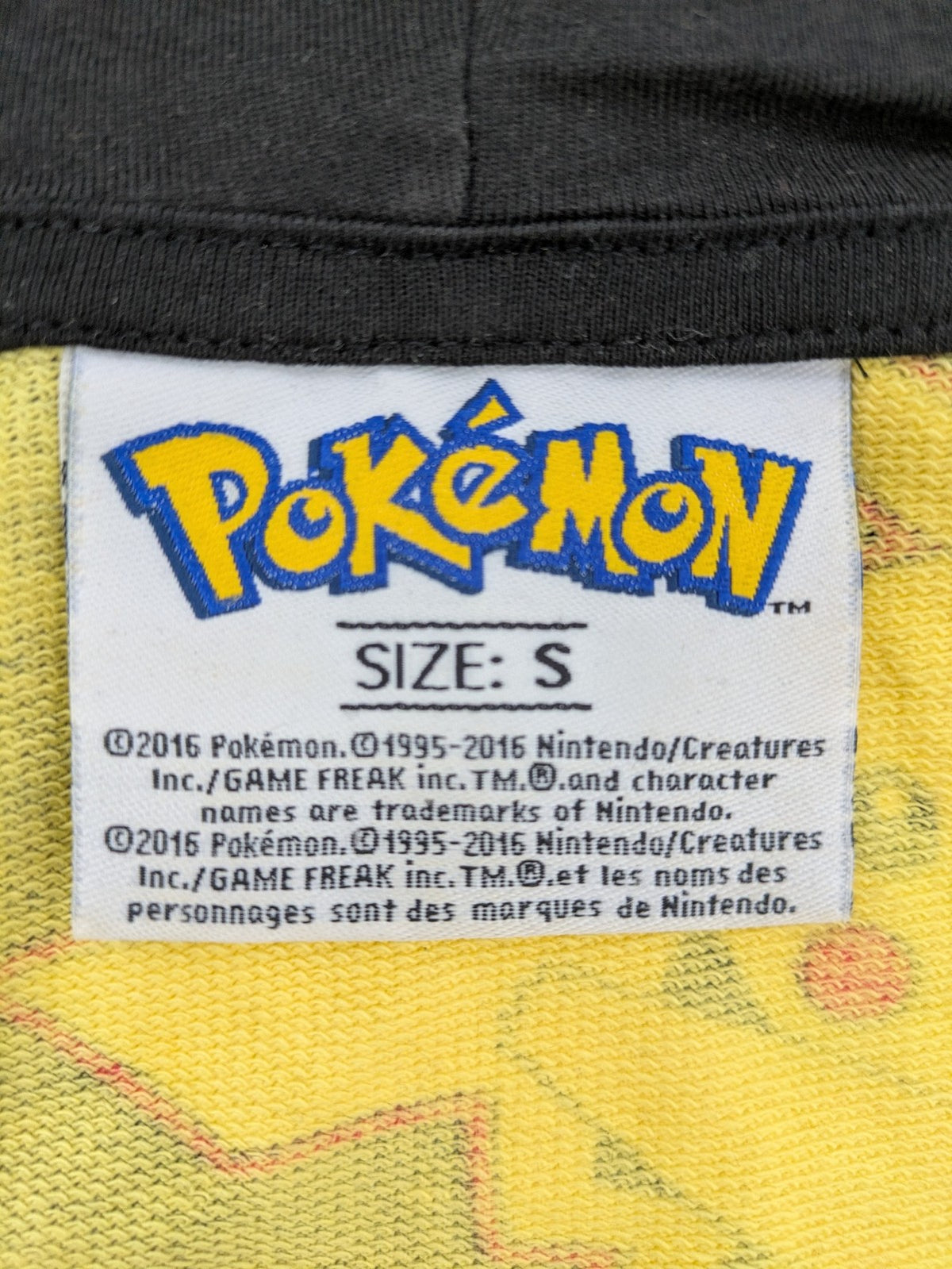 Herren black zip-through hoodie with vibrant Pikachu allover print and yellow lining.