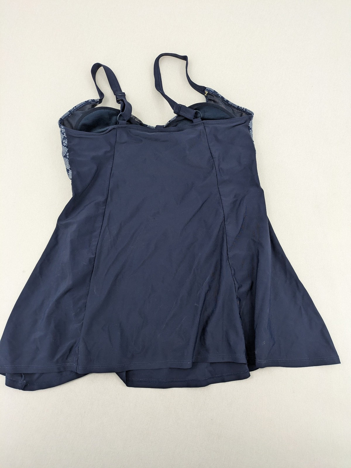 Muster blue one-piece swimsuit with geometric pattern and adjustable straps.