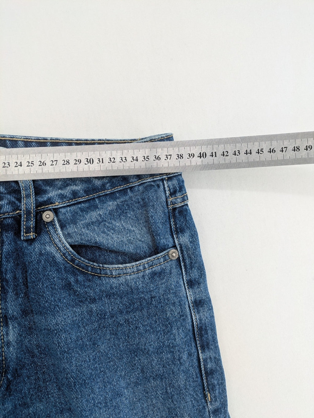 FSBN blue straight jeans with distressed knee rips and classic button fly.
