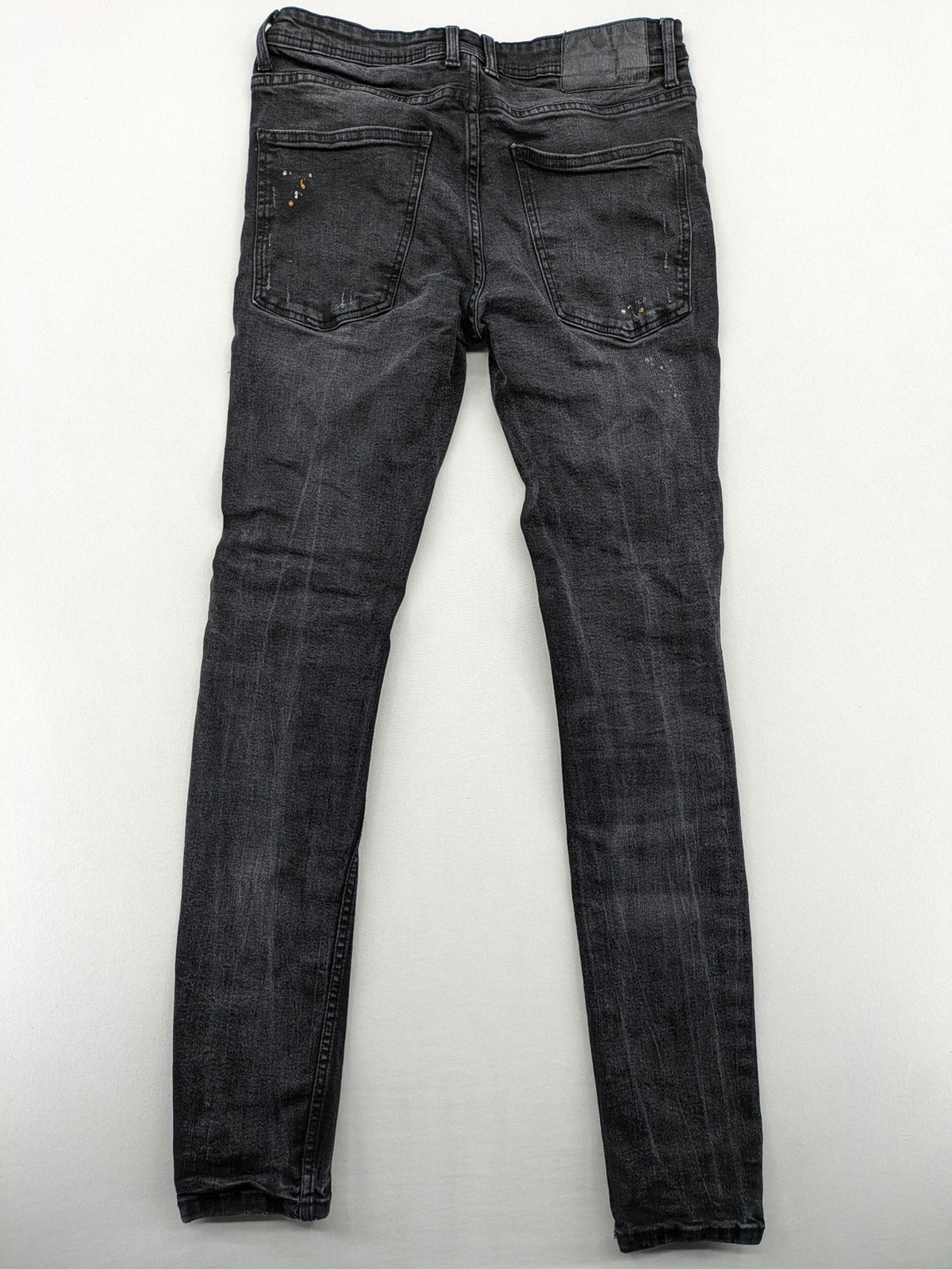 Black Squad skinny fit jeans black distressed ripped design with subtle paint splatter.