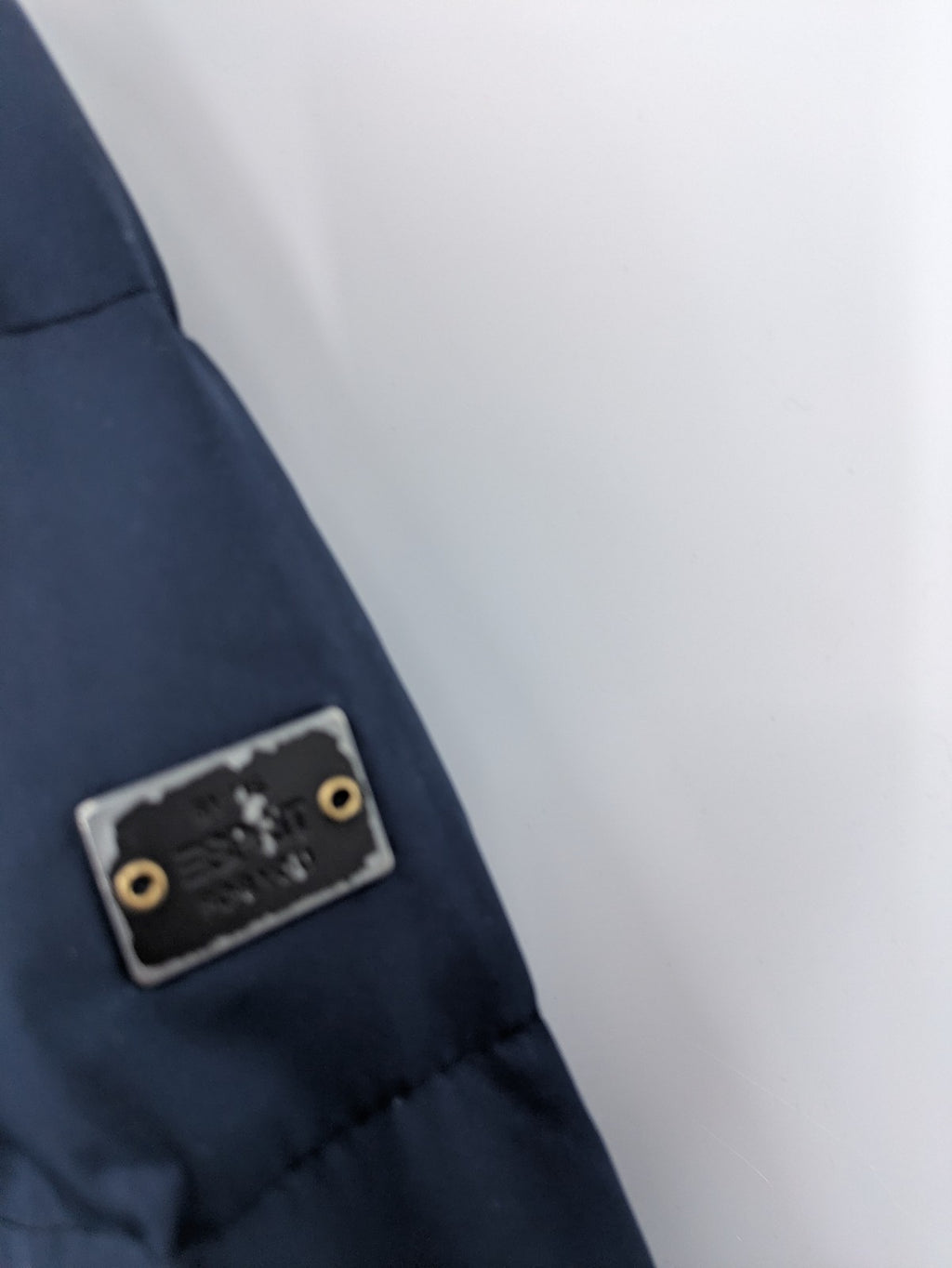 Esprit navy puffer jacket with belt, high collar, ribbed inner lining, and button placket.