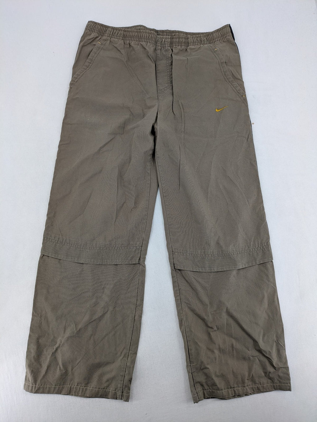 Nike khaki training pants with logo, elastic waistband, and practical pockets.