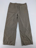 Nike khaki training pants with logo, elastic waistband, and practical pockets.