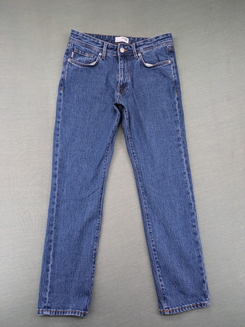 Selected Homme blue straight fit jeans with classic five-pocket design and medium wash denim.