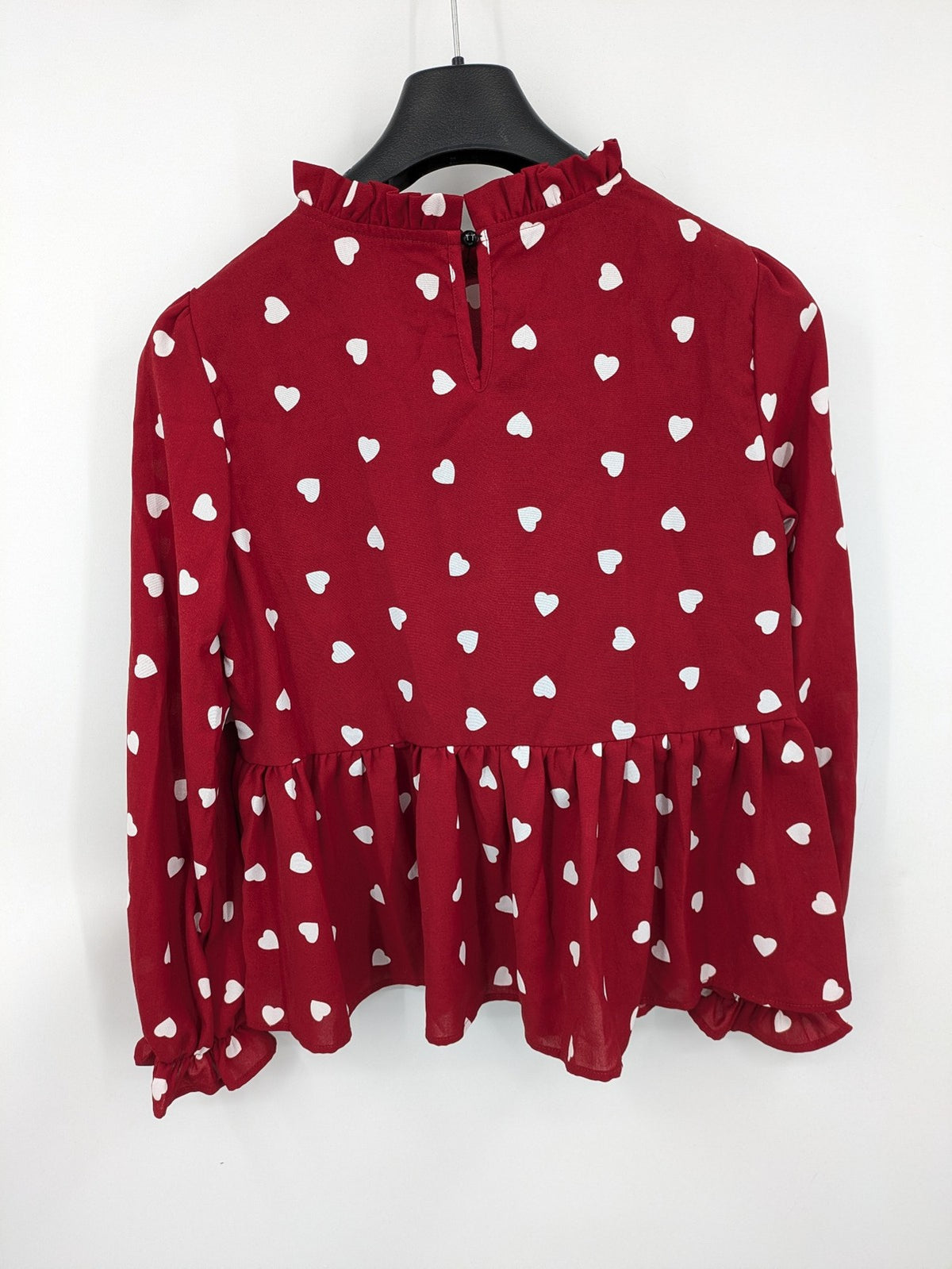 SHEIN burgundy top with white heart pattern and ruffled neckline detail.