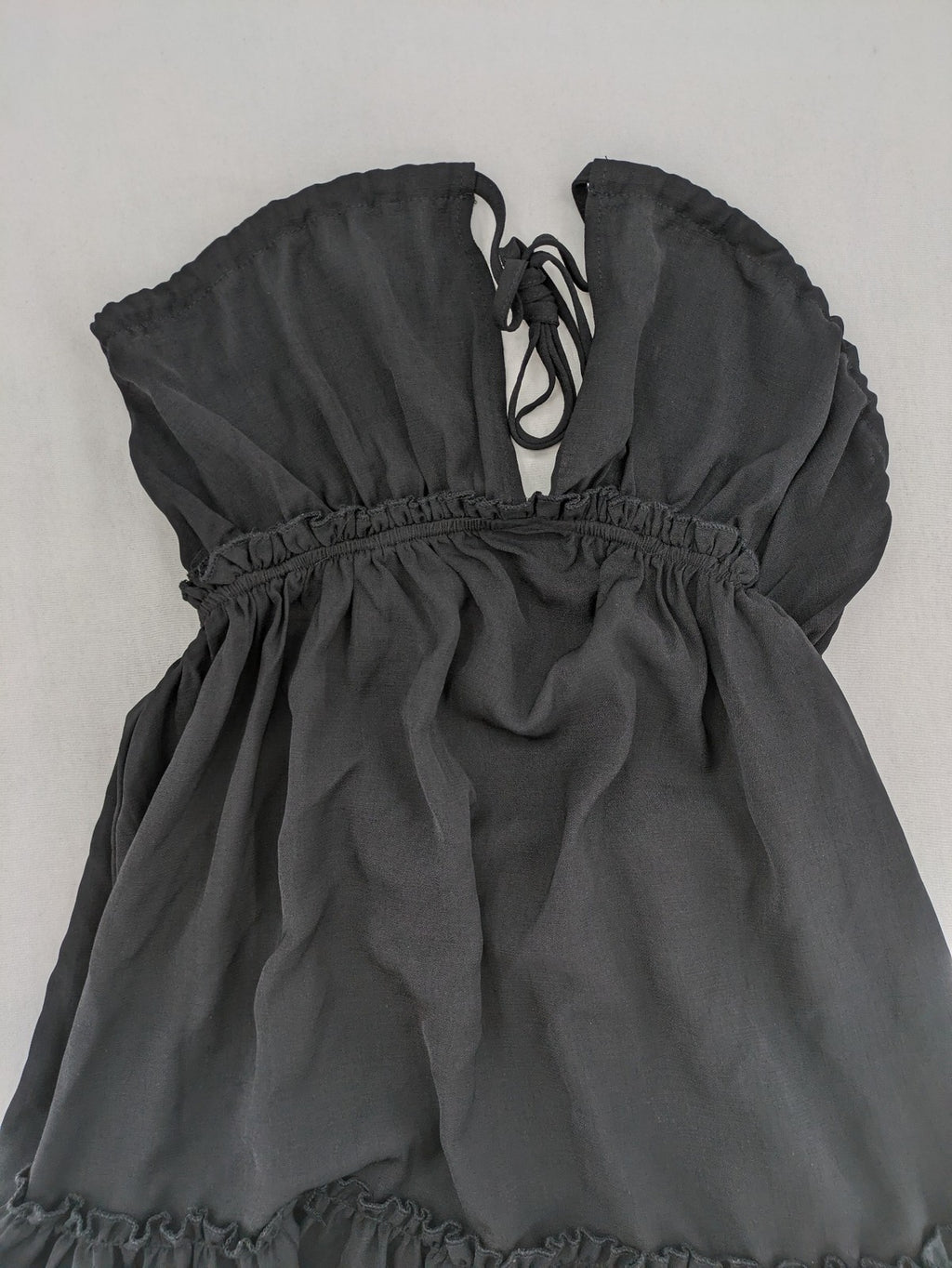 SHEIN grey mini dress with open back, adjustable tie, and ruffled hem.