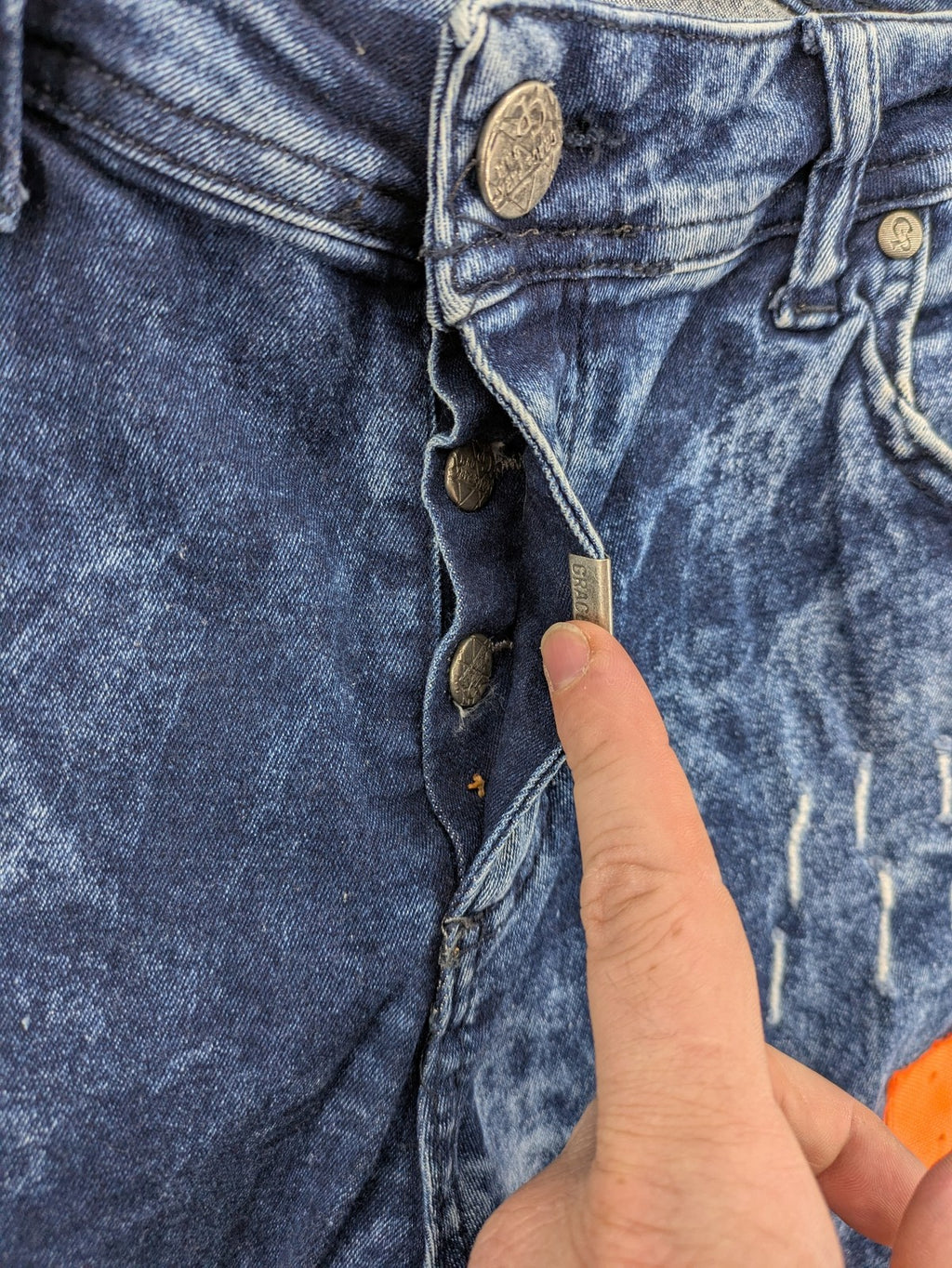 Stark straight jeans multi distressed acid wash with orange patches and side stripes.